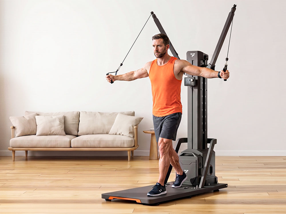 Man doing cable chest fly exercise on all-in-one smart home cable resistance trainer, compact full body strength training machine for living room home gym