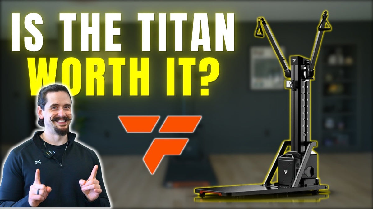 Is the Titan worth it? A man points to the FitTransformer Titan machine with yellow triangle handles.